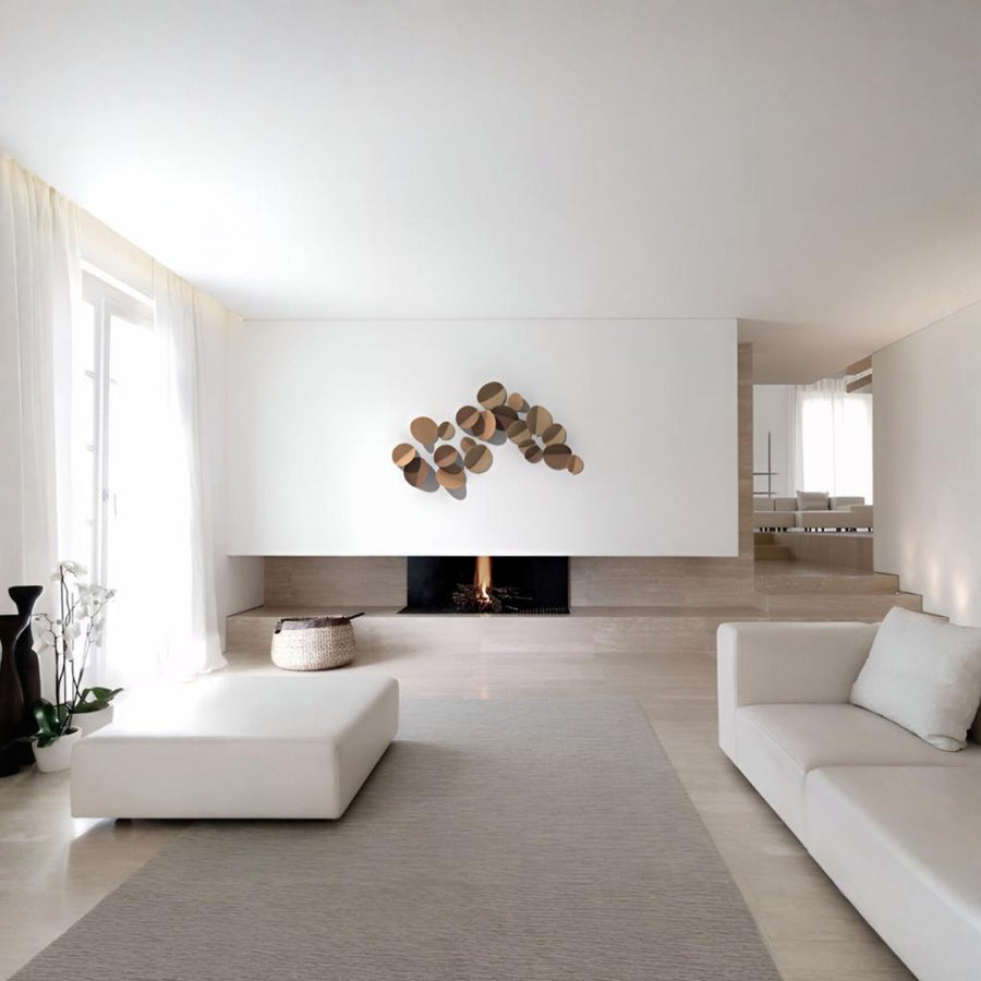 Modern living room with white walls, a fireplace, minimal furniture and ceramic wall art by Gardeco available at Spacio retail stores in Mumbai & Kolkata.  