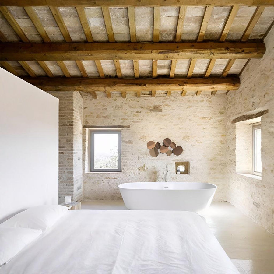 Modern bathroom with a freestanding bathtub, wooden ceiling, and ceramic wall art by Gardeco available at Spacio retail stores in Mumbai & Kolkata.  