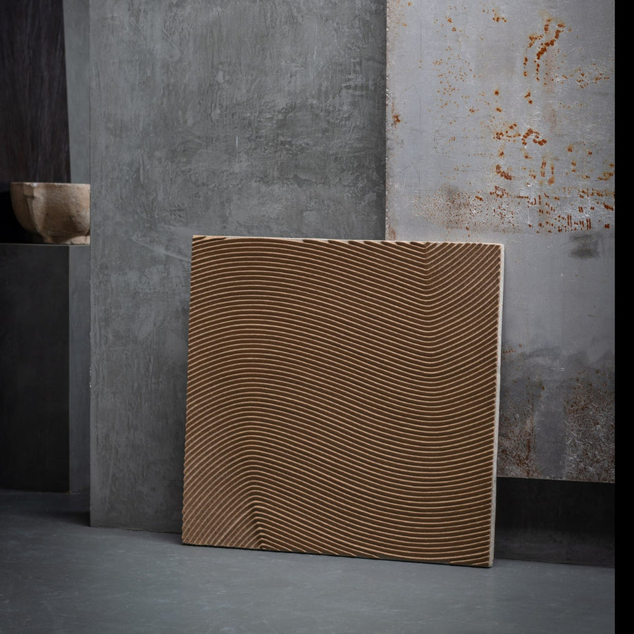 Square wall art with wavy pattern against a textured wall by Gardeco available at Spacio retail stores in Mumbai & Kolkata.  