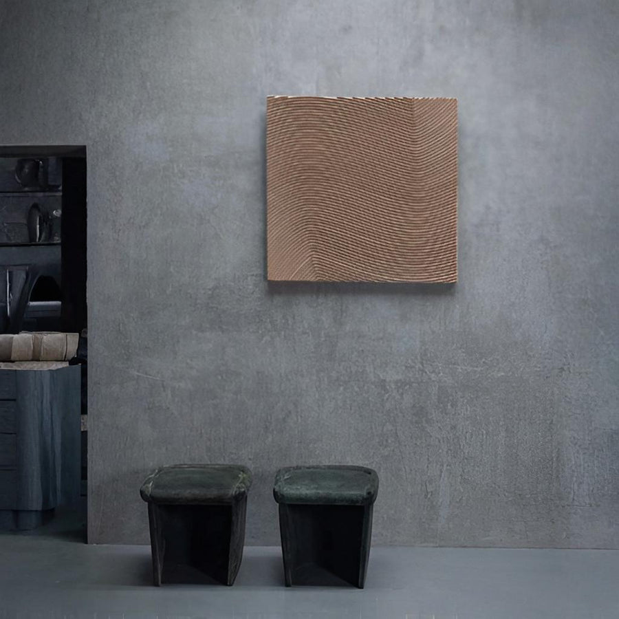 Abstract wall art piece on a gray wall with two green stools in front by Gardeco available at Spacio retail stores in Mumbai & Kolkata. 