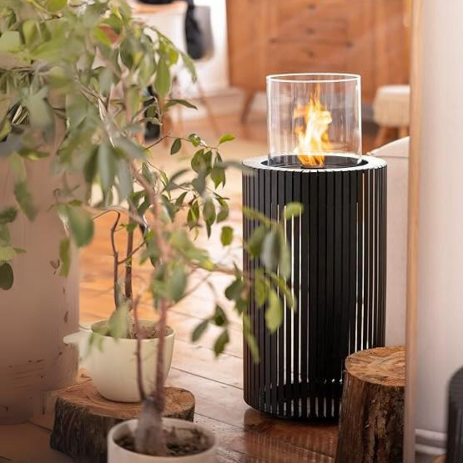 A black column fireplace in an indoor and outdoor setting. 