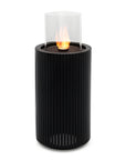 Black cylindrical fire pit called Madala with a glass cover on a white background from Planika  available at Spacio retail stores in Mumbai & Kolkata. 