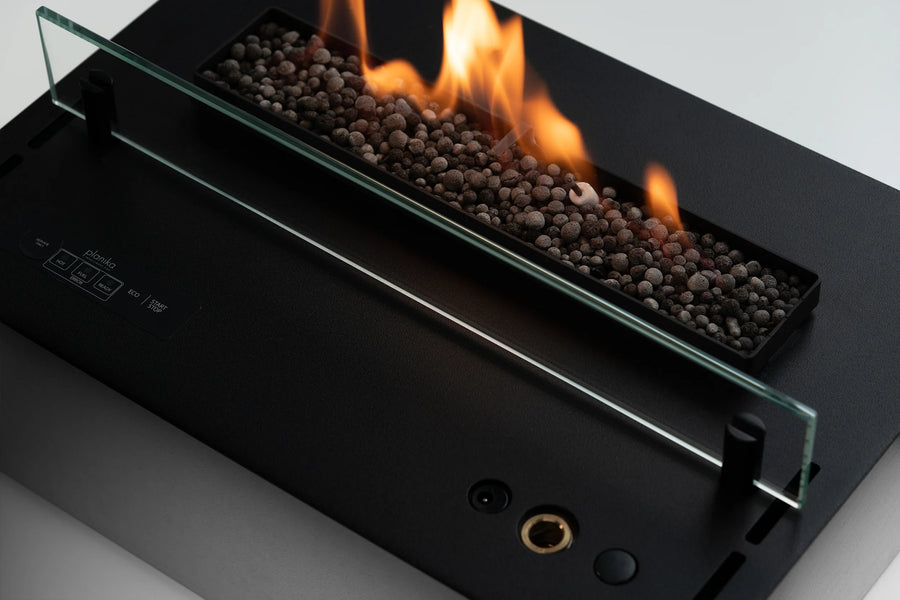 Planika's Modern bioethanol insert fireplace with glass front and visible flames on a neutral background available at Spacio retail stores in India