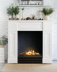 A fireplace with artificial logs from Planika inside a fireplace mantle. 