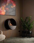 Modern living room with a wall-mounted fireplace, beige sofa, and abstract painting.
