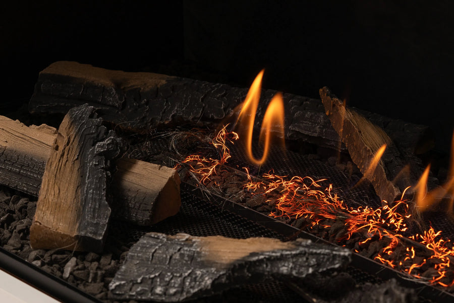 Fireplace with burning wood and flames against a dark background