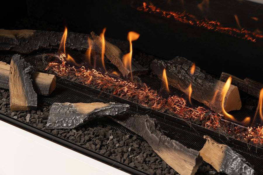 Close-up of a fireplace with burning logs and flames.