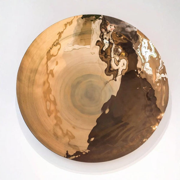 Decorative large glass wall plate with gold and black abstract design on a white background by Gardeco available at Spacio retail stores in Mumbai & Kolkata.  