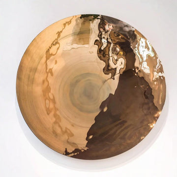 Decorative large glass wall plate with gold and black abstract design on a white background by Gardeco available at Spacio retail stores in Mumbai & Kolkata.  