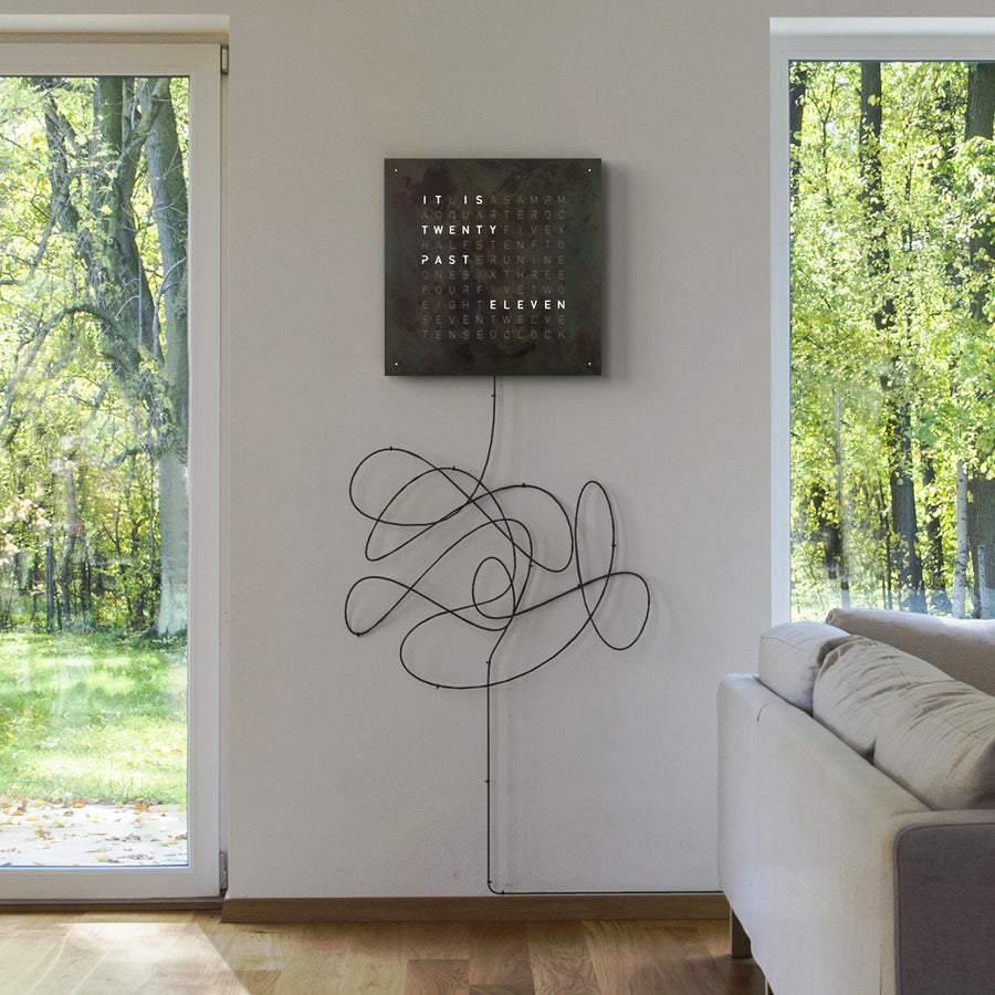 Qlocktwo Earth 45 Creator's Edition Raw Iron Limited Edition Clock on a wall of living interior room available at Spacio India for luxury home decor collection of Timepieces & Clocks.