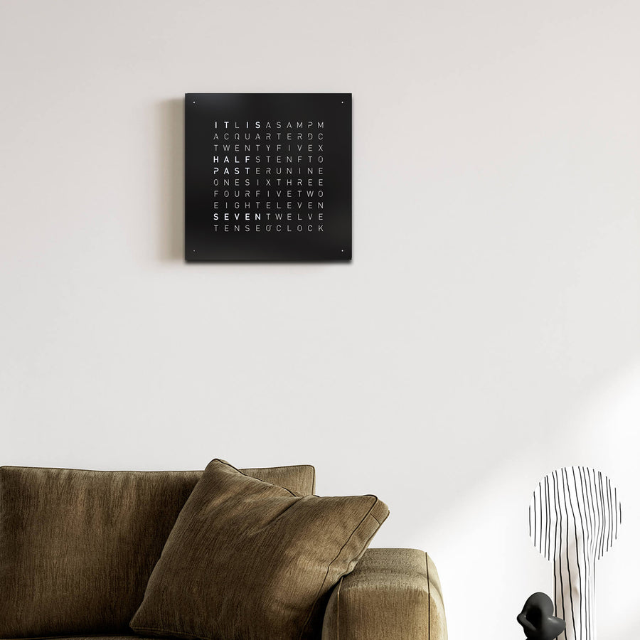 Qlocktwo Earth 45 Steel Black Pepper luxury Wall Clock in a modern living room interior available at Spacio India