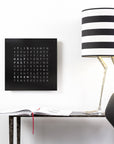 Qlocktwo Earth 45 Steel Black Pepper Clock, paired with a lamp and console table available at Spacio India from our luxury home decor collection for exclusive timepieces and clocks.