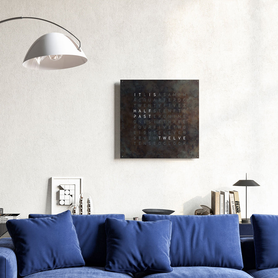 Qlocktwo Earth 90 Creator's Edition Raw Iron Limited Edition Clock in living room interior with Blue sofa & other home accessories available at Spacio India for luxury home decor collection of Timepieces & Clocks.