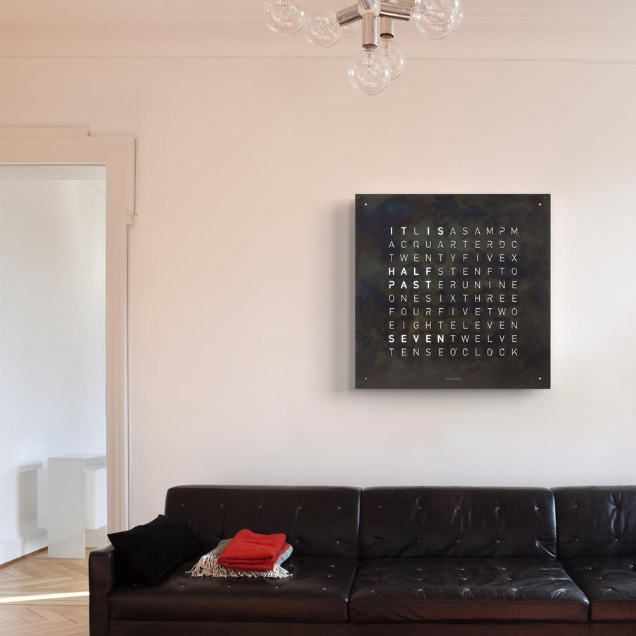 Qlocktwo Earth 90 Creator's Edition Raw Iron Limited Edition Clock on a wall of living interior room available at Spacio India for luxury home decor collection of Timepieces & Clocks.