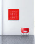 Qlocktwo Earth 90 Steel Red Pepper Limited Edition Clock in a seating area of modern interior with Chair available at Spacio India for luxury home decor collection of Timepieces & Clocks.