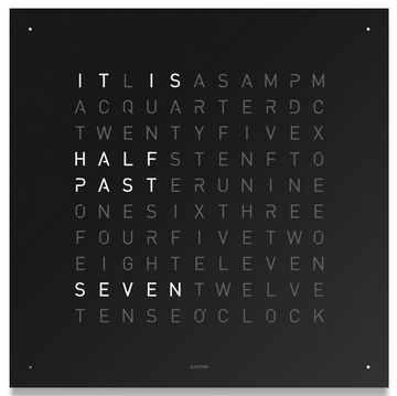 The Clock Qlocktwo Classic Black Ice Tea by Qlocktwo is a sleek design object that features an illuminated corner point system. This black wall clock elegantly displays the time with the words it is half past seven