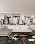 Hand-drawn fresco artwork of Stonehenge, handcrafted in Italy on plaster sheets with Carrara marble and Roman travertine powder, part of Spacio's Luxury Art Surface collection in a luxury living room with wooden flooring and sofa