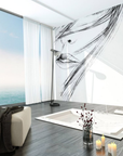 Charcoal sketch fresco mural featuring a detailed face with flowing lines, handcrafted on Italian plaster with Carrara marble and travertine. Featured on a wall in a living room next to sea