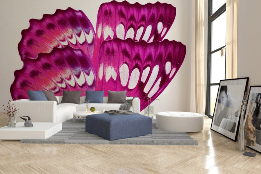 A vivid fresco mural showcasing magenta and white butterfly wings, crafted with Italian plaster using Carrara marble and travertine for a luxurious finish. Featured on a double height living room wall