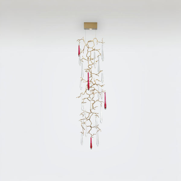 Decorative hanging wall lamp with gold branches and red accents on a white background