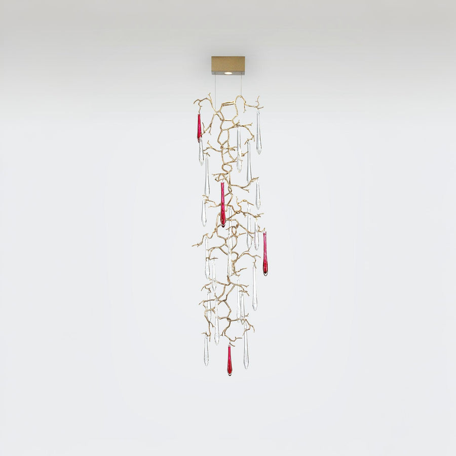 Decorative hanging wall lamp with gold branches and red accents on a white background