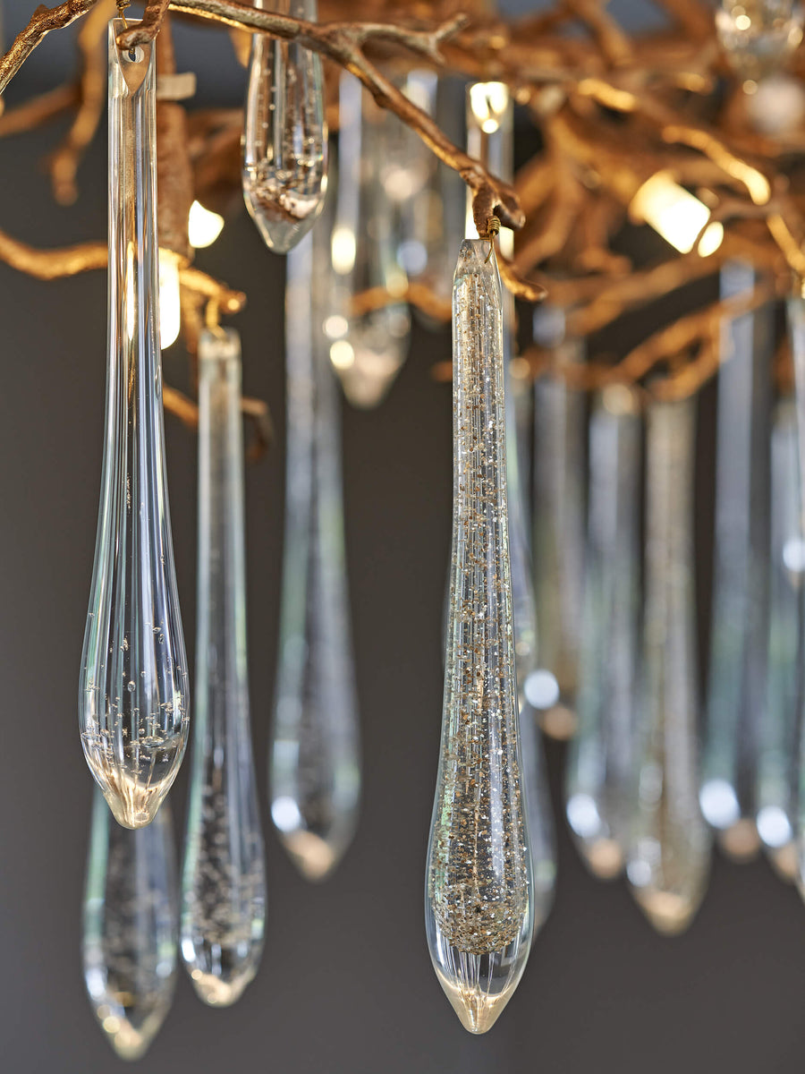 The Serip Aqua Chandelier by Serip features a stunning arrangement of glass drops, creating a nature-inspired and mesmerizing display.