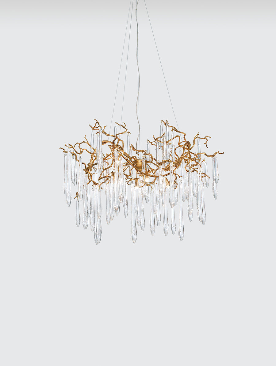 A Serip Aqua Chandelier, part of Serip's Aqua Collection, hanging elegantly on a white wall.