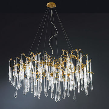 A Serip Aqua Chandelier adorned with clear crystal drops is suspended elegantly from the ceiling.