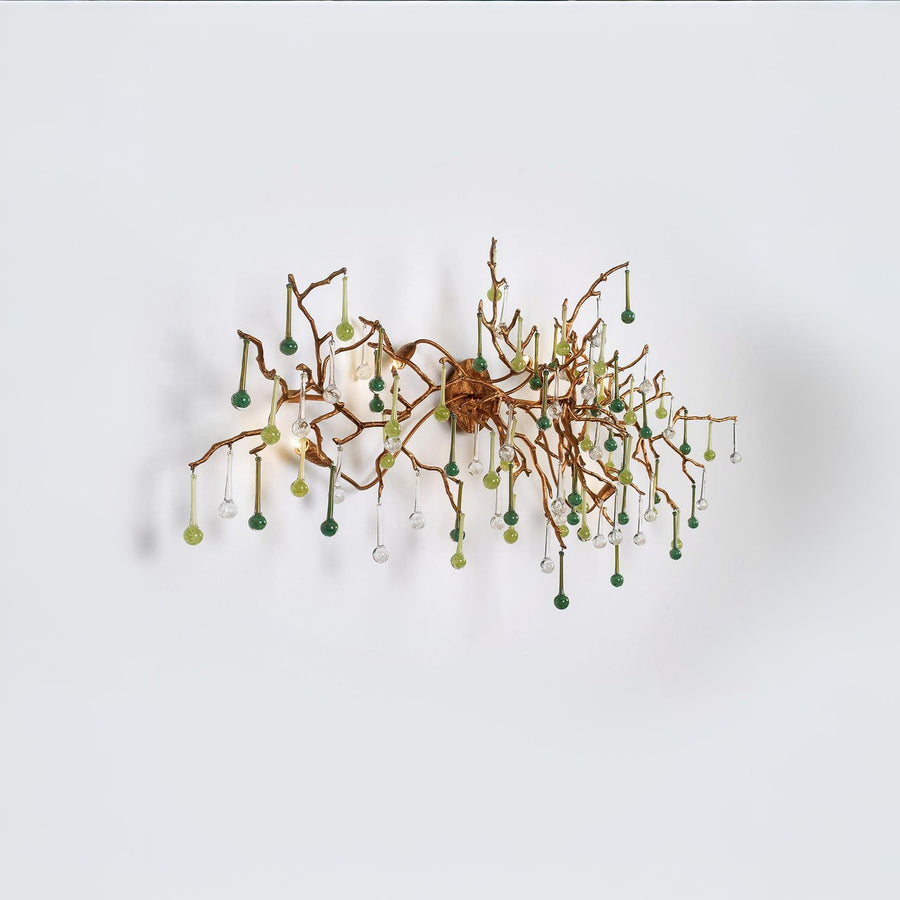 Side view of a wall light with Glass shaped falling droplets of water hanging from gold colour branches