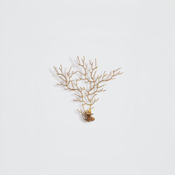 A wall light in the share pf a coral sea fan on a light grey background
