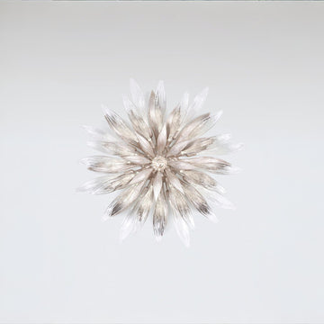 A decorative nature inspired flower shape light on a grey background