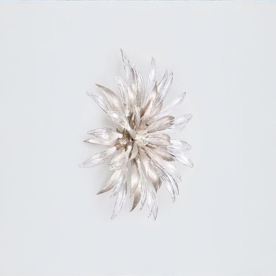 A decorative nature inspired flower shape wall light on a grey background