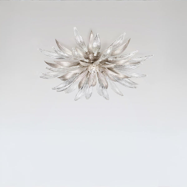 Decorative ceiling light with a starburst design on a plain background
