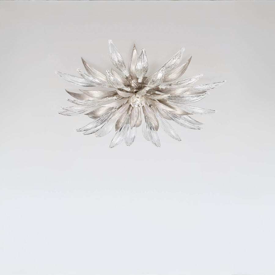 Decorative ceiling light with a starburst design on a plain background