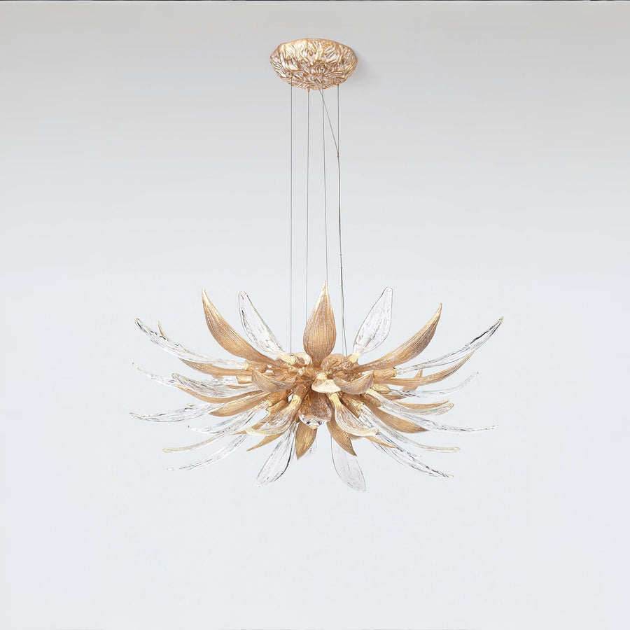 A flower shaped chandelier suspending from the ceiling on a light grey colour background. 