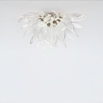 A flower shaped ceiling light in glass and metal fixed on the ceiling on alight grey colour background