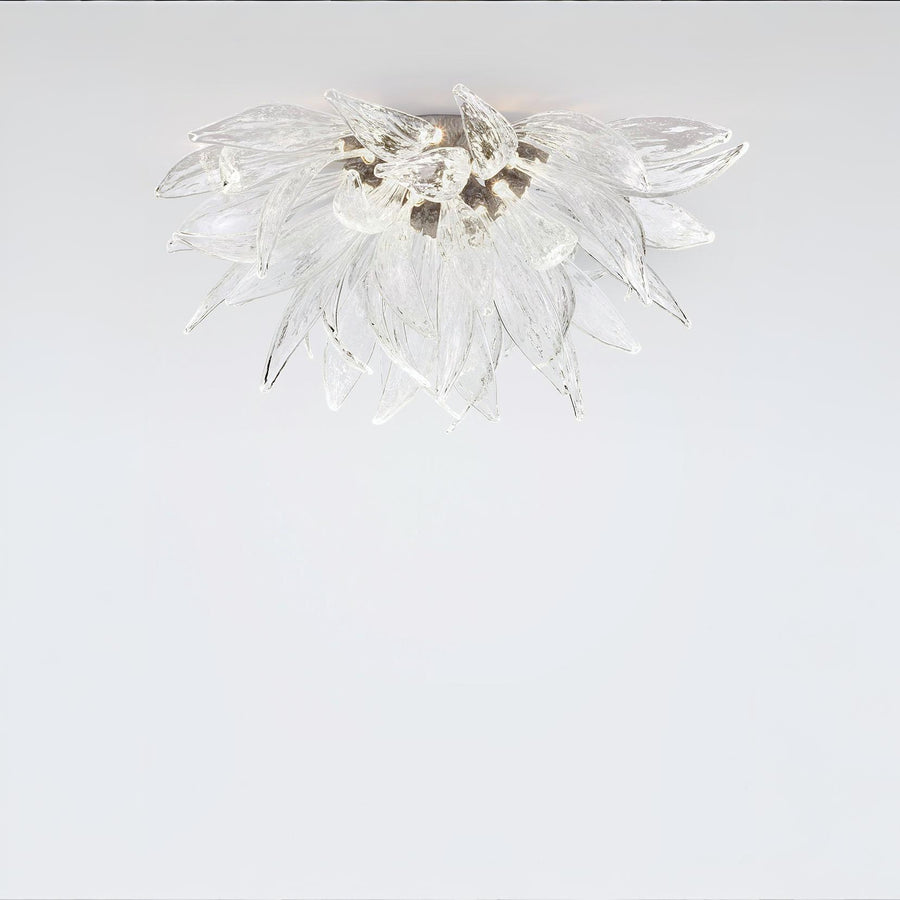 A flower shaped ceiling light in glass and metal fixed on the ceiling on alight grey colour background