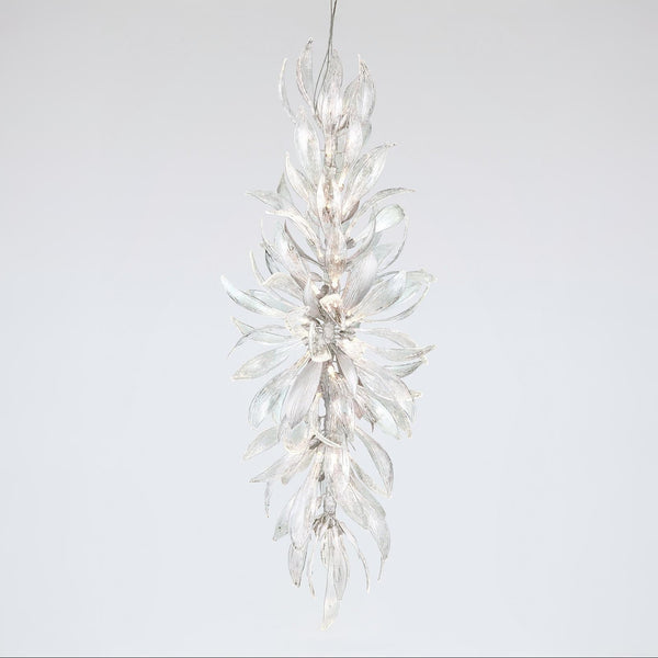A grand chandelier in the shape a of a forest flower bloom on a light grey colour background