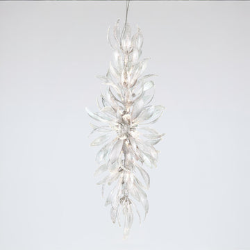 A grand chandelier in the shape a of a forest flower bloom on a light grey colour background
