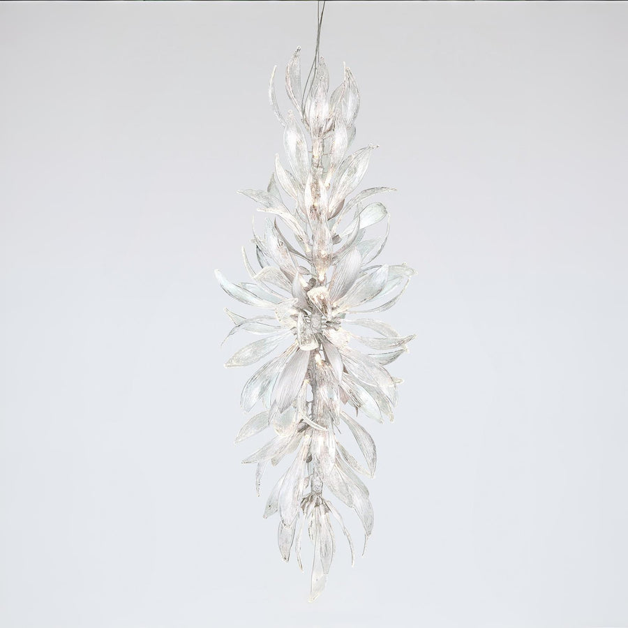 A grand chandelier in the shape a of a forest flower bloom on a light grey colour background