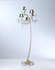 An ornate floor lamp with falling droplets shaped glass and small shades on a grey colour back ground. 