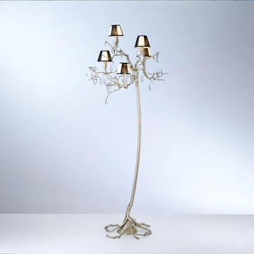 An ornate floor lamp with falling droplets shaped glass and small shades on a grey colour back ground. 