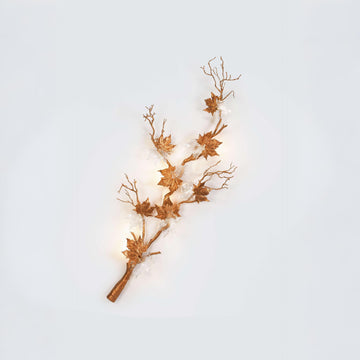 A wall light from Serip's Folio collection available at Spacio on a white background featuring leaves. branches and glass. 