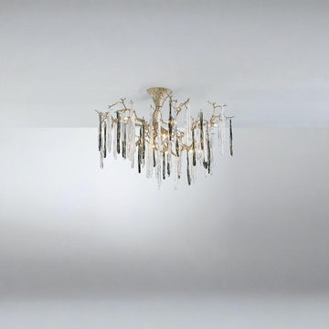 A chandelier suspended from a ceiling with colourful glass icicles hanging from golden colour branches on a dark grey background.