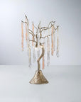 A table lamp with colour glass icicles hanging from golden colour branches on a light grey colour background