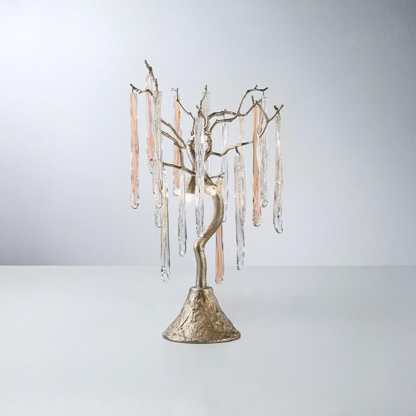 A table lamp with colour glass icicles hanging from golden colour branches on a light grey colour background