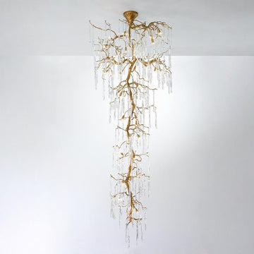 A double height chandelier in the shape of hanging stalactites on w white background. 