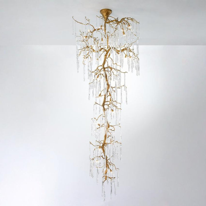 A double height chandelier in the shape of hanging stalactites on w white background. 
