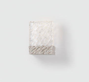 Decorative wall light with wavy texture on a white background