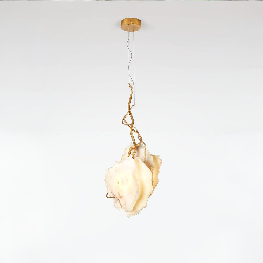 Modern pendant light with gold fixture and marble on a white background